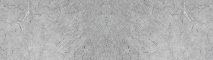 灰色の手漉き和紙の表面のテクスチャー。横に長いパノラマの背景素材。