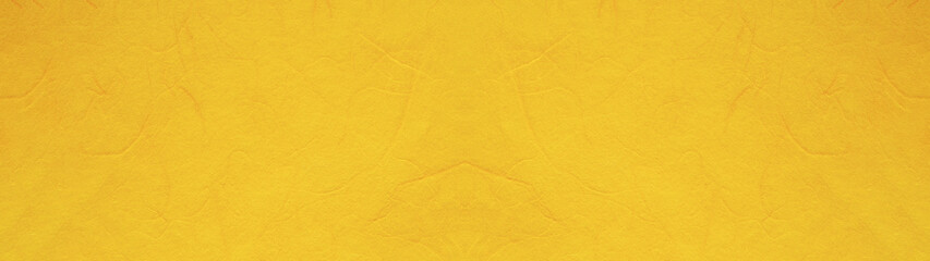 黄色の手漉き和紙の表面のテクスチャー。横に長いパノラマの背景素材。