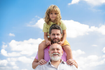 Portrait of men generation grandfather father and grand son outdoor on sky. Fathers day concept....