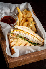 ..Club sandwich with bacon cheese and ham vegetable and sauce in box