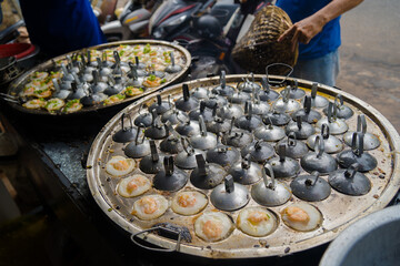 Sizzling Vietnamese mini shrimp pancake and onion- Vietnamese cuisine, Banh Khot. Vendor hawker...
