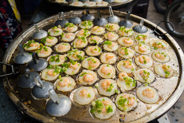 Sizzling Vietnamese mini shrimp pancake and onion- Vietnamese cuisine, Banh Khot. Vendor hawker...