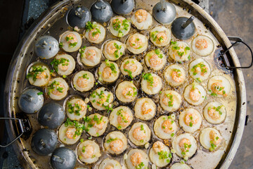 Sizzling Vietnamese mini shrimp pancake and onion- Vietnamese cuisine, Banh Khot. Vendor hawker...