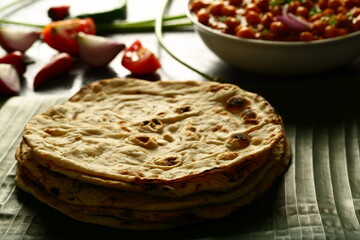 Whole-wheat  roti served with chickpeas curry, chana masla, - Indian vegetarian meal.