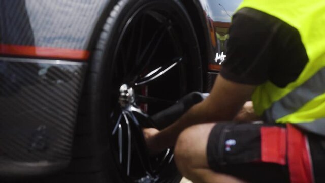 Luxurious car been getting ready for the transport in slow motion