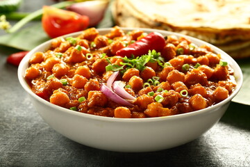 Indian street foods background- chickpeas curry, chana, channa, masala served with chapathi,
