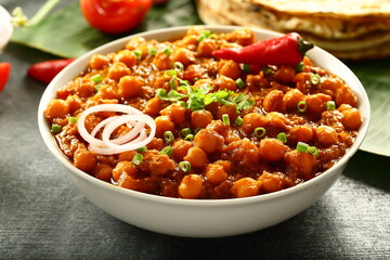 Homemade chickpeas curry- chana masala- Indian vegetarian cooking recipes background.