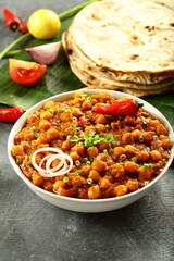 Chana masala, chickpeas curry served with Roti - Indian vegan diet meal.