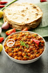 Chana masala, chickpeas curry served with Roti - Indian vegan diet meal.