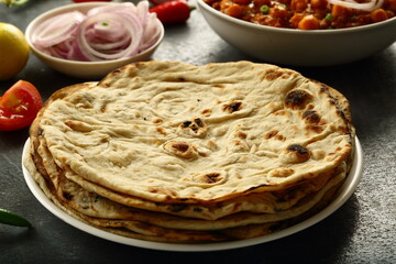 Indian  roti- whole wheat flat bread served with onion salad and chickpea curry.
