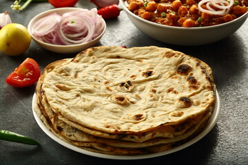 Indian  roti- whole wheat flat bread served with onion salad and chickpea curry.