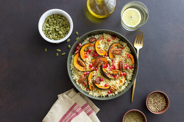 Bulgur with pumpkin, pomegranate and pecan nut. Healthy eating. Vegetarian food.