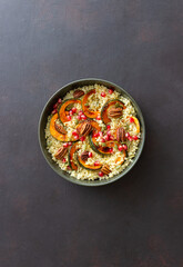 Bulgur with pumpkin, pomegranate and pecan nut. Healthy eating. Vegetarian food.