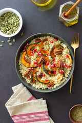 Bulgur with pumpkin, pomegranate and pecan nut. Healthy eating. Vegetarian food.