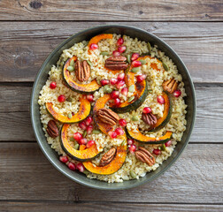 Bulgur with pumpkin, pomegranate and pecan nut. Healthy eating. Vegetarian food.