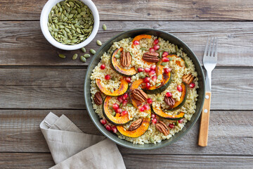 Bulgur with pumpkin, pomegranate and pecan nut. Healthy eating. Vegetarian food.