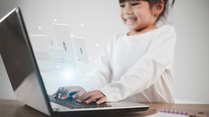 Asian girl using laptop for streaming online, watching video on internet, live study, tutorial, online learning, education, homeschooling. during Covid-19 pandemic lockdown.