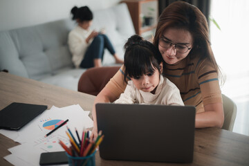 Mother working at home-office with daughter on her lap