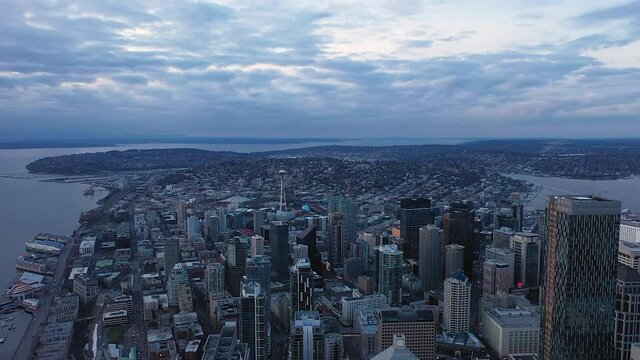Wide arial view of Seattle with the Puget Sound on the left and Lake Union on the right.