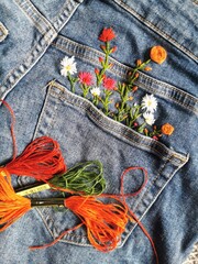 Creative DIY project, hand embroidery at home on jeans, creative hobby, clothes recycle, floral...