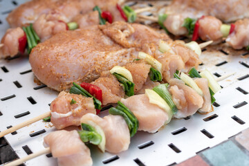 Chicken breast and pork meat pulled in wooden skewer with fresh colorful and tasty vegetables