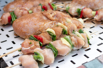 Chicken breast and pork meat pulled in wooden skewer with fresh colorful and tasty vegetables