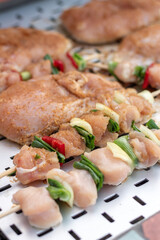 Chicken breast and pork meat pulled in wooden skewer with fresh colorful and tasty vegetables