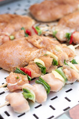 Chicken breast and pork meat pulled in wooden skewer with fresh colorful and tasty vegetables