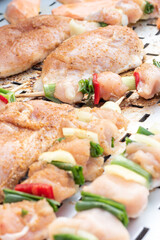 Chicken breast and pork meat pulled in wooden skewer with fresh colorful and tasty vegetables