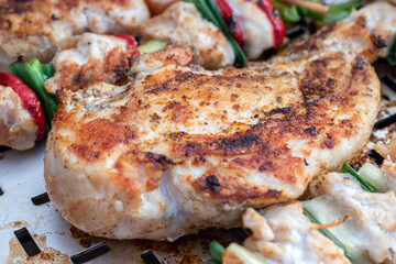 Chicken breast and pork meat pulled in wooden skewer with fresh colorful and tasty vegetables