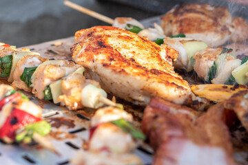 Chicken breast and pork meat pulled in wooden skewer with fresh colorful and tasty vegetables
