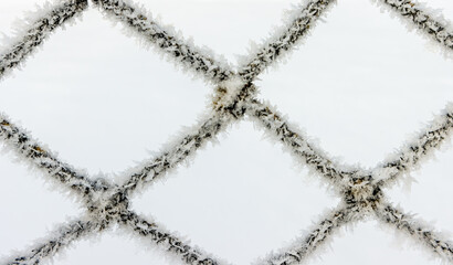 Frozen football net network in the winter up close