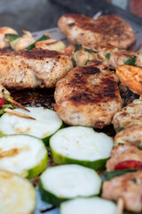 Chicken breast and pork meat pulled in wooden skewer with fresh colorful and tasty vegetables