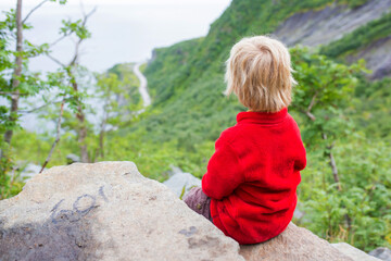 Children, toddler, brothers and father, climbing the stairs to Reinebringen, trekking path leading...