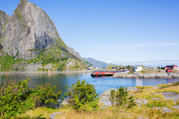 Fototapeta na wymiar Amazing view of a norwegian beautiful nature and typical small fishing cabins on a sunny summer day over the fjords