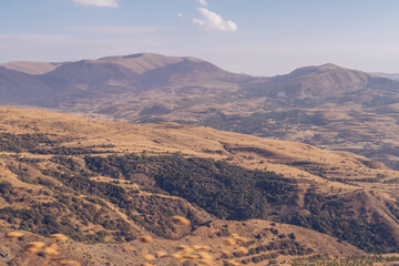 Armenia mountain autumn view. Dry land mountain range and steppe picturesque landscape view with blue sky. Stock photography.
