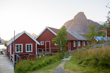 Fototapeta na wymiar Scenic panorama view of norwegian beautiful nature and small fishing villages with typical rorbu wooden red cabins in Lofoten, Norway