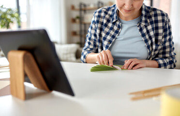 diy, art and hobby concept - close up of happy smiling woman with tablet pc computer making paper craft at home