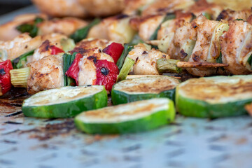 Chicken breast and pork meat pulled in wooden skewer with fresh colorful and tasty vegetables