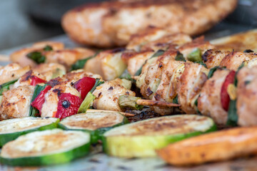 Chicken breast and pork meat pulled in wooden skewer with fresh colorful and tasty vegetables