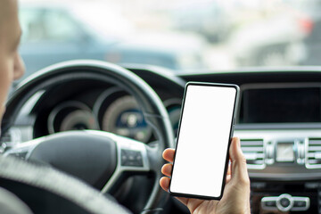 Man driver using smart phone in car during traffic jam, blank white screen for design purpose 