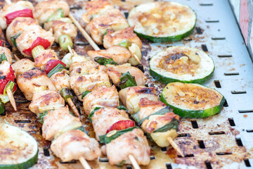 Chicken breast and pork meat pulled in wooden skewer with fresh colorful and tasty vegetables