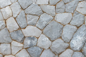 Background and textured of big old grey stone, rock wall with different size.