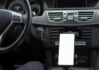 Smartphone in a car use for Navigate or GPS. Driving a car with Smartphone in holder. Mobile phone with isolated white screen. Blank empty screen. Empty space for text. Copy space