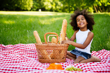 Beautiful african american child enjoying family picnic in the nature.