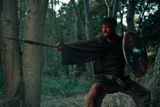 Aggressive warrior fighting with spear and shield