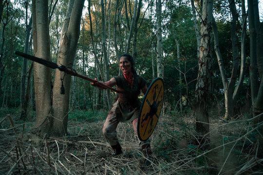 Aggressive woman attacking with spear and shield