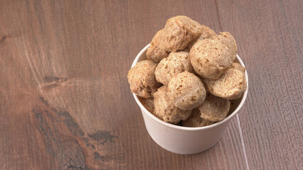 Raw soya chunks on dark background. Healthy, nutritious soybean meat, chunks isolated.Vegan food concept.
