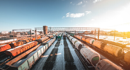 Fototapeta premium Freight trains from a height at the marshalling yard. Delivery of goods by freight train. Railroad cars at the station