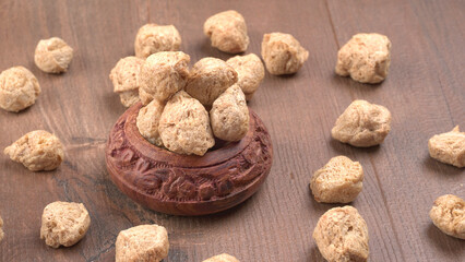 Raw soya chunks on dark background. Healthy, nutritious soybean meat, chunks isolated.Vegan food concept.
